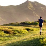 Young_man_running_in_mountains_Hawaii_CHJ06045
